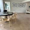 Beige stone flooring tiles in large dining room