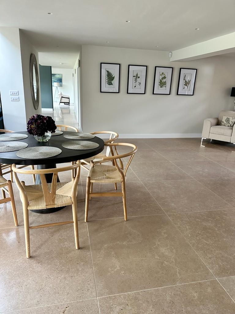 Beige stone flooring tiles in large dining room