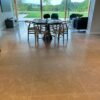beige stone floor tiles in large dining room with view onto the garden