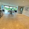 Beige stone flooring in kitchen and dining room