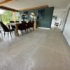 Dining area with large table and grey stone floor tiles
