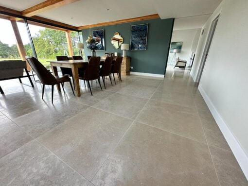 Dining area with large table and grey stone floor tiles