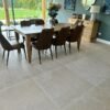 Dining room with garden view and grey beige stone floor tiles