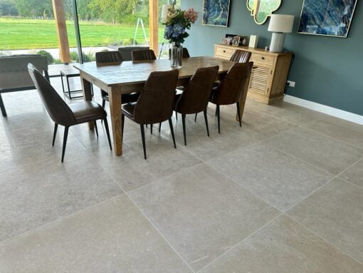 Dining room with garden view and grey beige stone floor tiles
