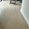 Beige stone flooring in a large luxury hallway