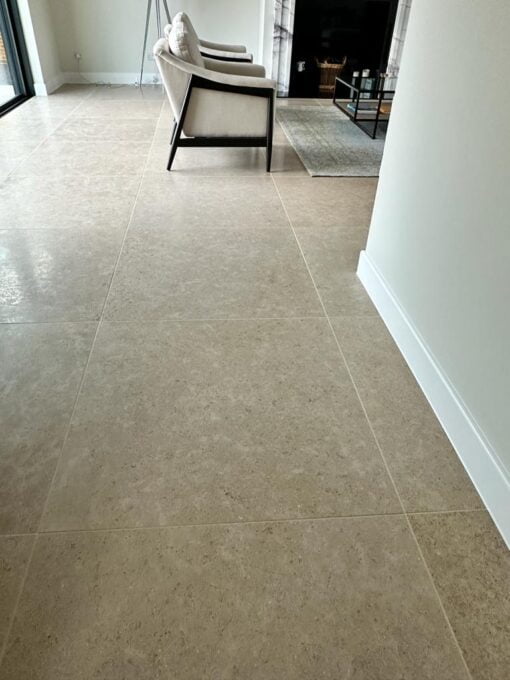 Beige stone flooring in a large luxury hallway